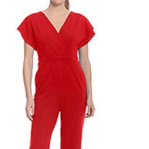 London style short sleeve jumpsuit. V neck. Fabric crepe. Inseam 29 1/2 inches.